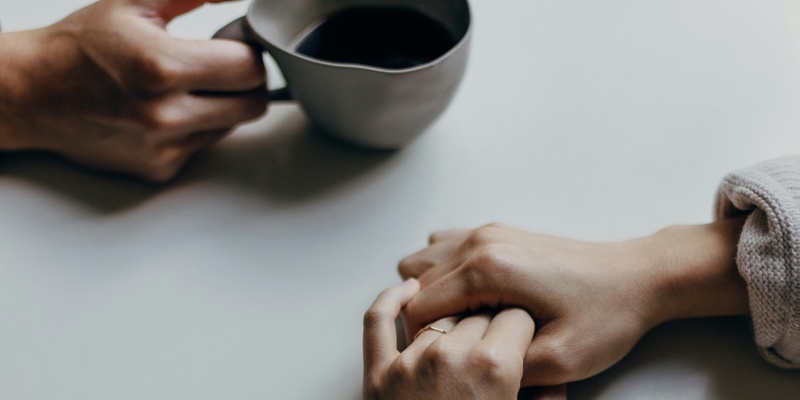 Couple's hands on a table pictured during mediation.